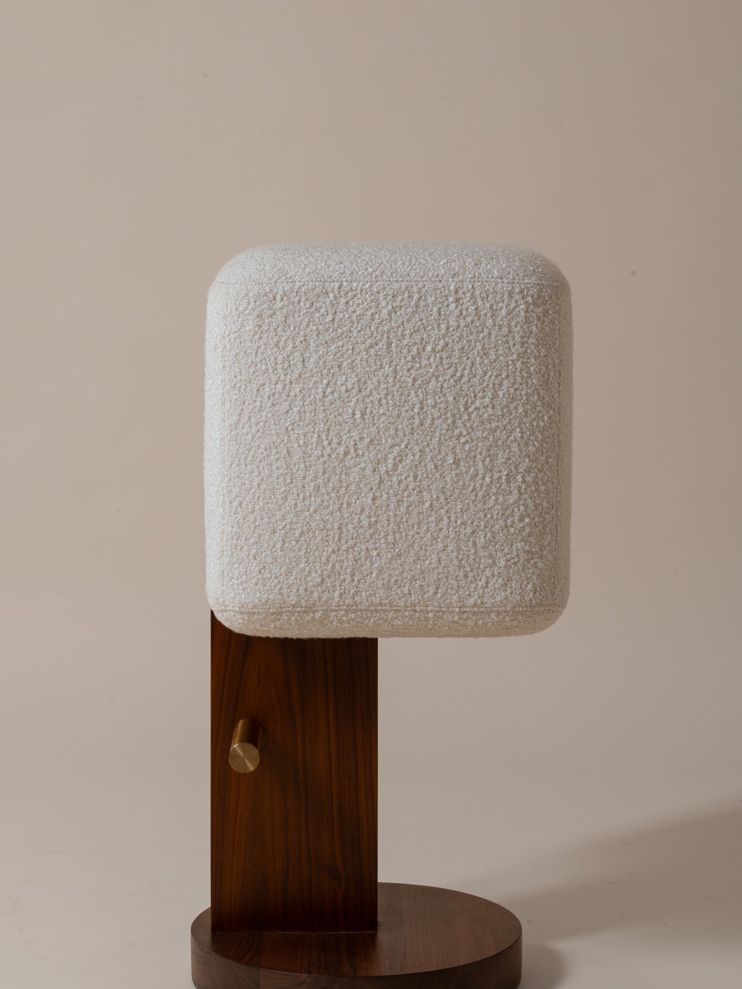 Side close-up view of cream bouclé upholstery and walnut pedestal on Moment 2.5 Ice Cream Bar Stool
