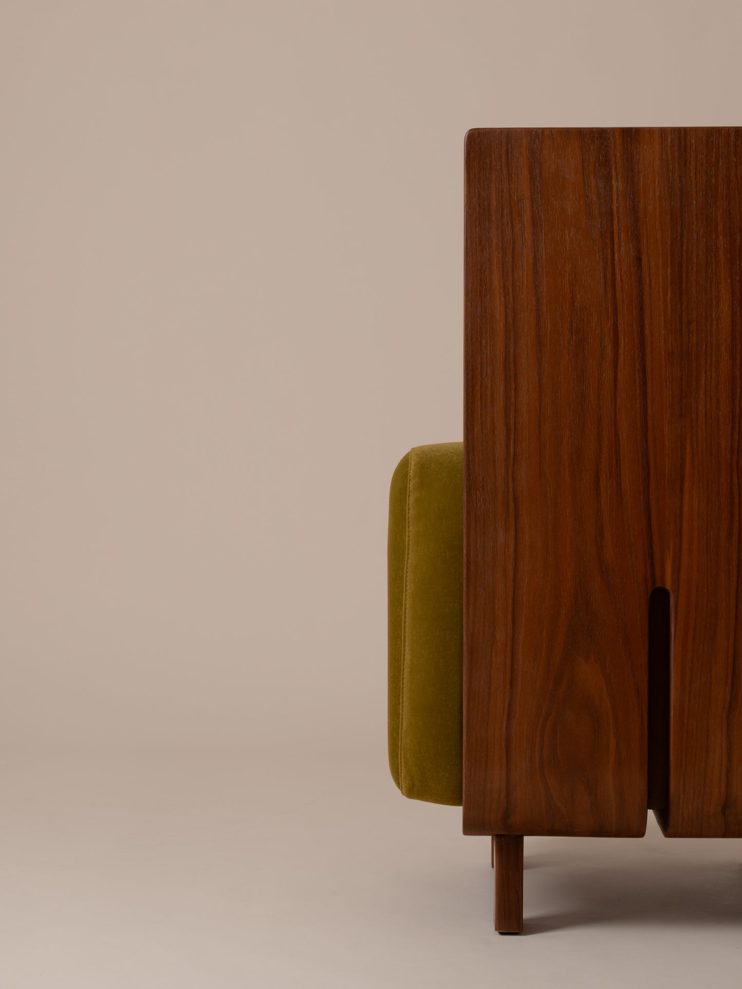 Close-up back view of olive green velvet upholstery and walnut wood frame on Moment 2.5 Onigi Chair