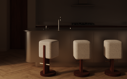 Three Form + Moment Ice Cream Bar Stool in cream bouclé with walnut wood pedestal and brass articulated footrest, styled in modern kitchen