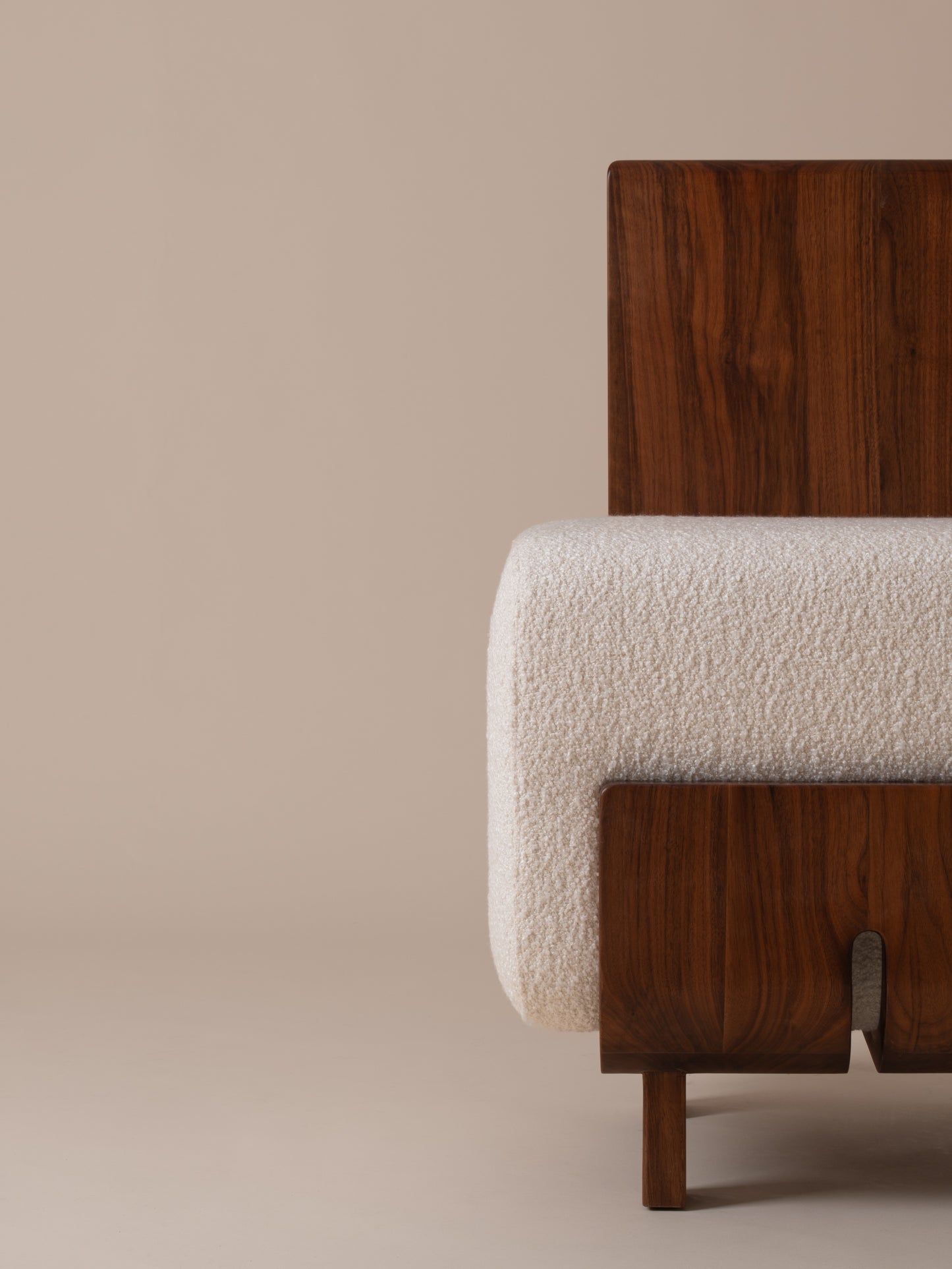 Close-up front view of plush cream bouclé seat and walnut base on Moment 2.5 Onigi Chair
