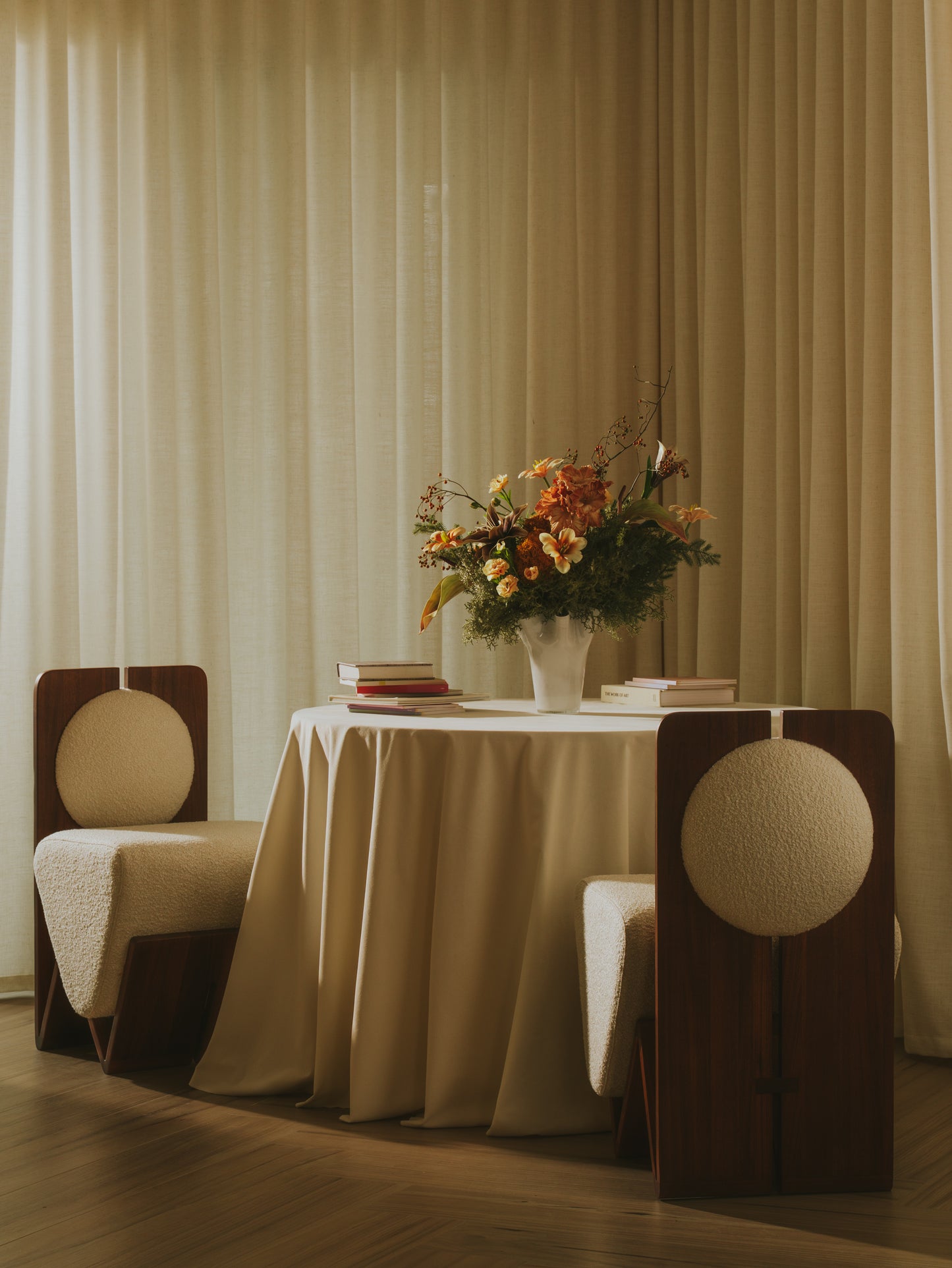 Moment 2.5 W Chair in contemporary dining setting with walnut frame and plush bouclé upholstery