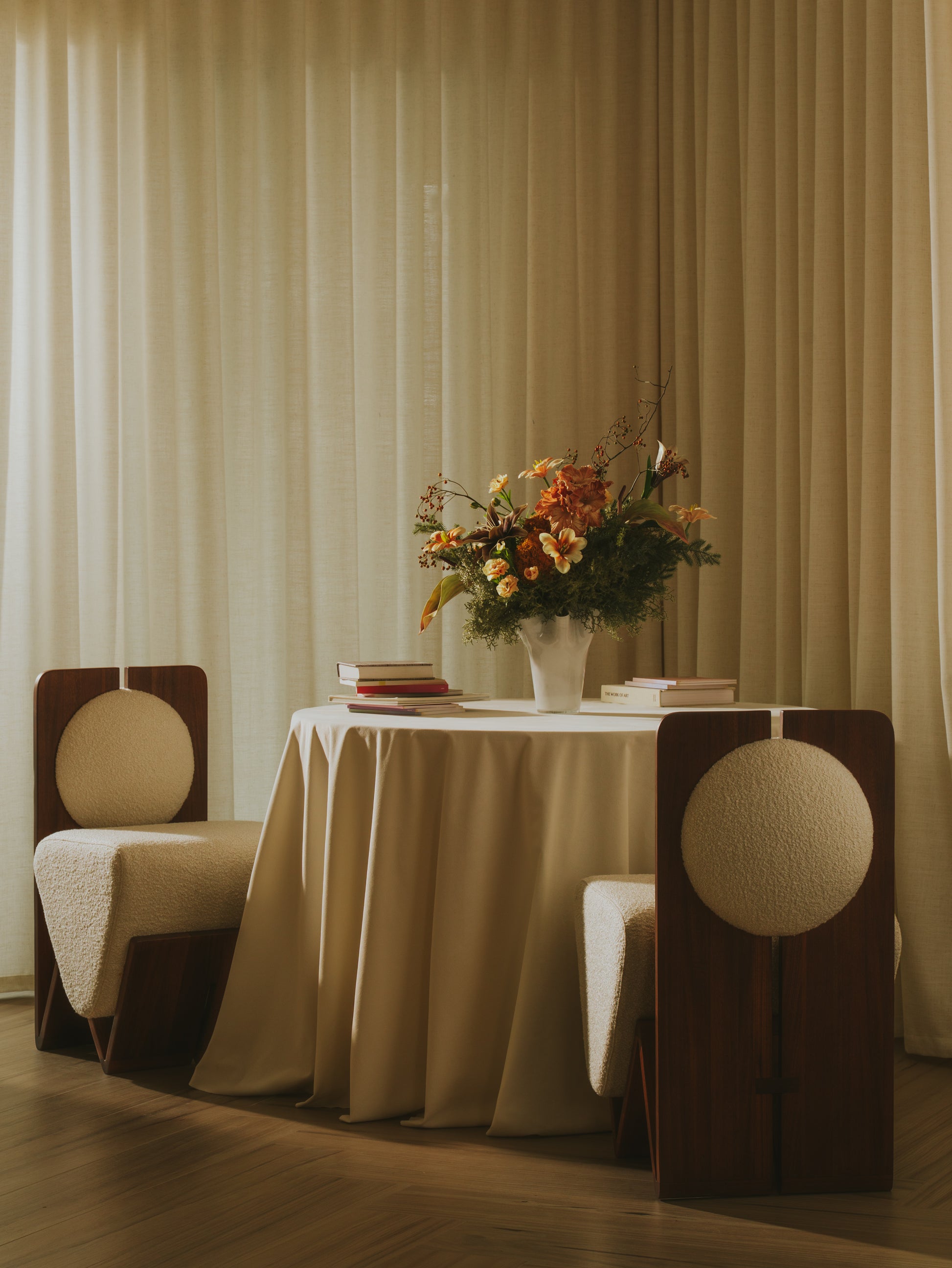 Moment 2.5 W Chair in contemporary dining setting with walnut frame and plush bouclé upholstery